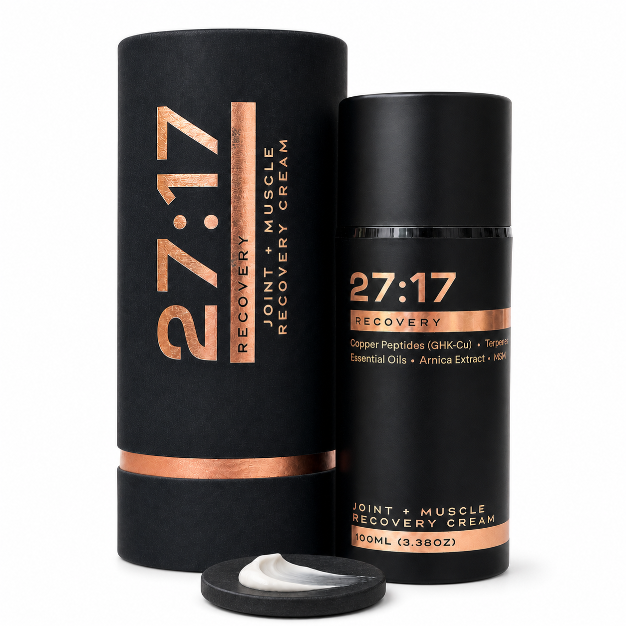 Black 27:17 Recovery Muscle Cream bottle with its matching cylindrical packaging box and a small dollop of white cream in front, on a white background.